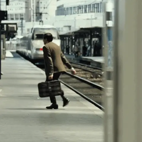A commuter running to catch a departing train and missing it